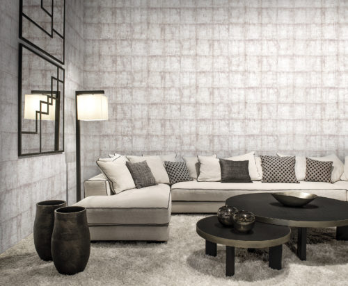 In this interior we show off the chequers design from our Khatam wallcovering collection: this classic design with a modern twist evokes the patina walls of Venetian palaces. Here it is combined with a sofa in the same white colour. Accessories are dark: black mirror, black standing lamp, dark brown vases, dark brown round coffee tables.