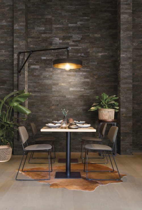 This dining room feels like going on a holiday. The tropical plants, the earthy wallcovering, the animal skin on the floor, the coconut bark wallcovering on the wall: the coconut tree, symbol of far-off tropical islands, is enveloped by bark that is striped, marbled and smooth yet coarse. Intense weathering adds beauty to the material with a harmony of tones softened by the elements.