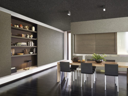 Contemporary kitchen with mica wallcoverings from the Graphite range. Wooden table with black chairs. In one of the walls shelves are hidden. Sliding doors.