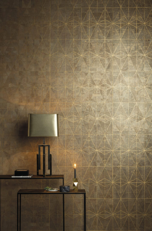 The celeste design from our Khatam wallcovering collection: ancient star inlay design evoking the elegance of gold leaf. A candle makes the gold foil shimmer.