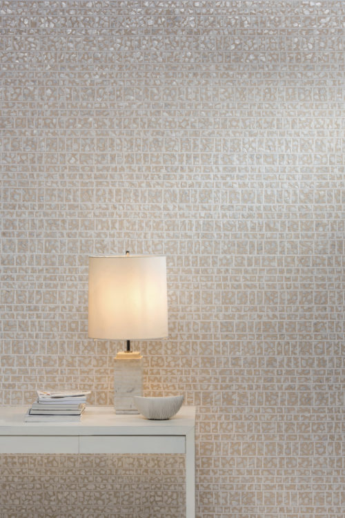 Wall showing of the capiz wallcovering from the Shades of Pale collection. The mother-of-pearl in the wallcovering goes well with the white lamp.