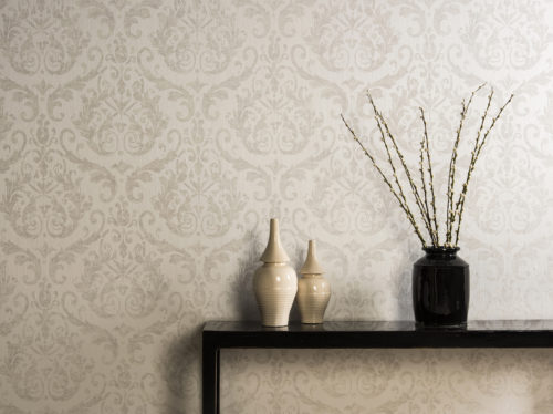 Regal interior picture of damask wallcovering in soft ones, branch with catkins and ivory coloured pots.