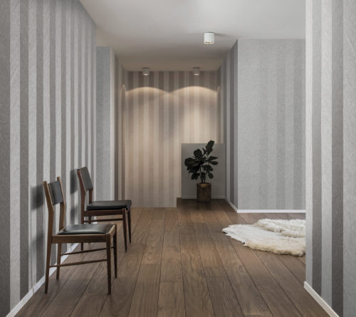 Waiting room with two chairs. Fluffy rug on the wooden floor. Plant in the back. Omexco Portfolio wallcoverings give a timeless touch to the whole.