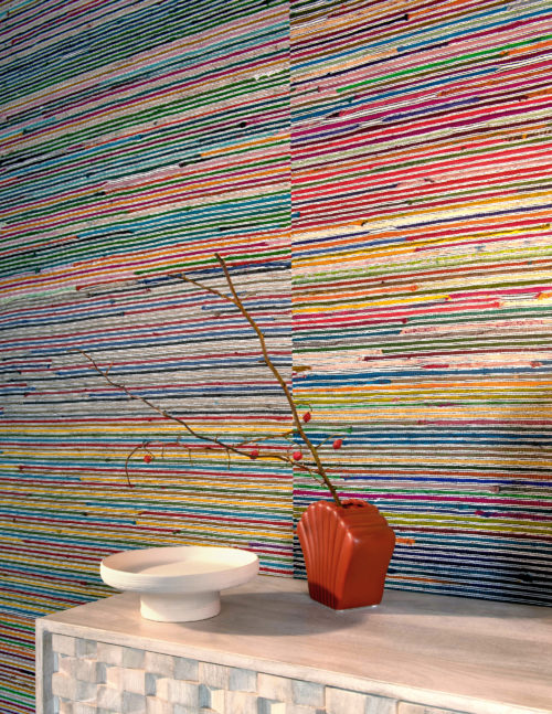 Closeup on the very colourful wallcoverings from Omexco's handmade collection Atelier. Recycled sari silk is twisted into ribbons and handwoven with paper strings. The handmade texture fills you with joy and beauty.