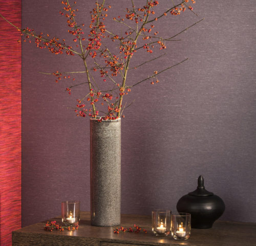 Warm setting with a grey vase with berries, candles, purple and bright red Elegance wallcovering.