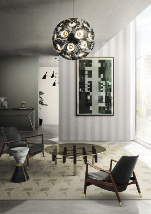 Living room with two leather chairs round a dark glass centre table. Outstanding chrome pendant lamp by Delightfull. Abstract painting. Infinity wallcoverings in grey shades.