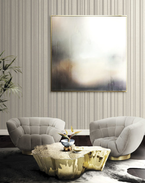 Tactile room with velvet chairs that make you think of hands to sit on. Vague pastel work of art, beige striped Infinity wallcovering.