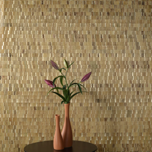 Omexco Nomad: waterlily leaves are woven in lively and generous colours. A detail of the yellow gold in this picture.