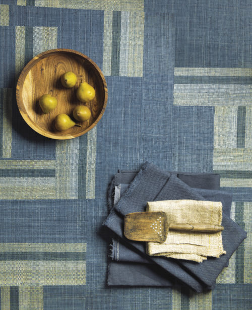 Handwoven raffia squares form a striking blue and beige patchwork in Boro style, reflecting Omexco's love and passion for authentic craftsmanship.