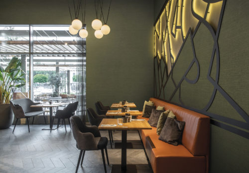 On the walls of this cosy, contemporary restaurant: the Abaca design in moss green from Omexco's High Performance Textures collection. It's a semi plain non-woven wallcovering with an intriguing texture, shown horizontally. Woven extra fine abaca. The abaca fibre we use as a grasscloth in Seraya and other collections is the inspiration.  It is the stem and supporting structure of the long leaves of the Abaca tree, a species of banana tree native to the Philippines.