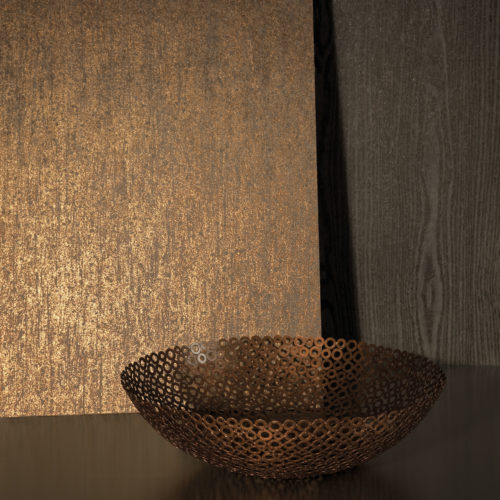 Little decor with shades of brown: dark tropical wood, copper bowl made out of rings, gold reflecting Kaleidoscope wallcovering.