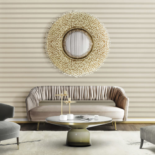 Clear sitting room with pink velvet sofa. The back fabric has nice creases and folds. Above it a mirror with mother-of-pearl details. Infinity wallcovering.