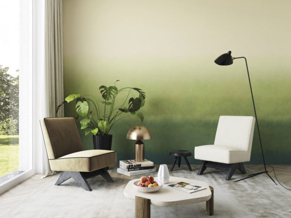 Impressive living room with two single seater sofas, a wooden geometrically shaped coffee table, black minimal floor lamp and large window to bring brightness to the space. We see a feature wall covered with 'Zenitude' design from Omexco's Joy collection: a breathtakingly beautiful gradient with shades of green.