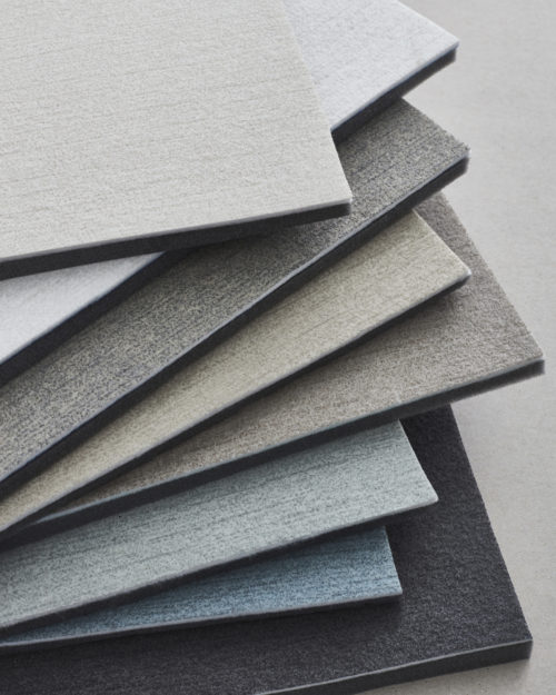 Une image d'échantillons de revêtements muraux dans les tons blanc, beige, bleu clair et anthracite de la collection acoustique Silence d'Omexco. Silence est un produit de haute qualité au design simple, ton sur ton. Le design est disponible dans une gamme subtile de 10 couleurs.