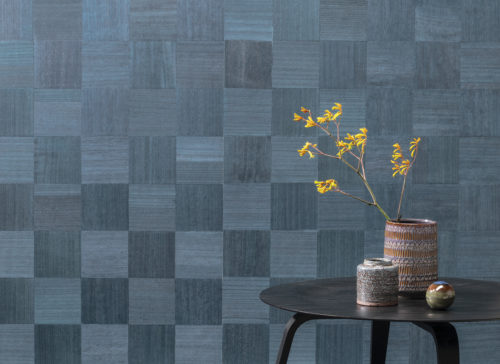 La collection Sycamore d'Omexco se définit par la célébration du bois naturel.  Nos revêtements muraux élégants et raffinés donnent vie à ce matériau noble et authentique. Détail du motif 'chess' vert/bleu : des carrés de bois orientés dans différentes directions comme sur un échiquier.